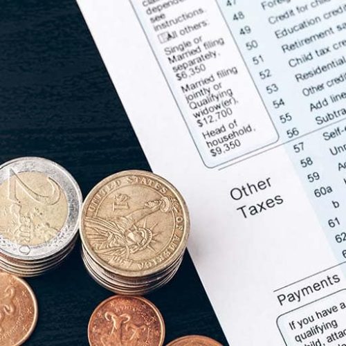 The close-up of accounting documents with money coins